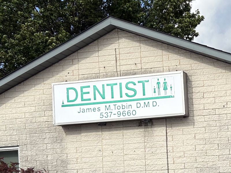 The Dentist sign outside the Unity Plaza office